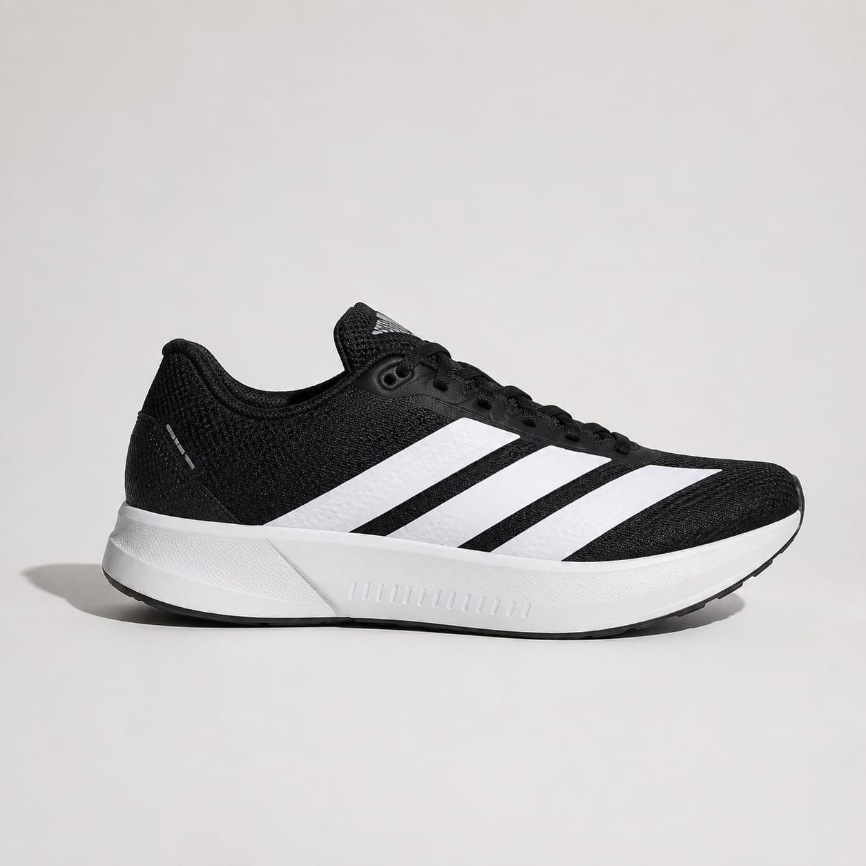 A black and white Adidas running shoe shown from the side against a light gray background.